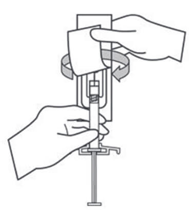 Diagram of person attaching the safety needle to the syringe.